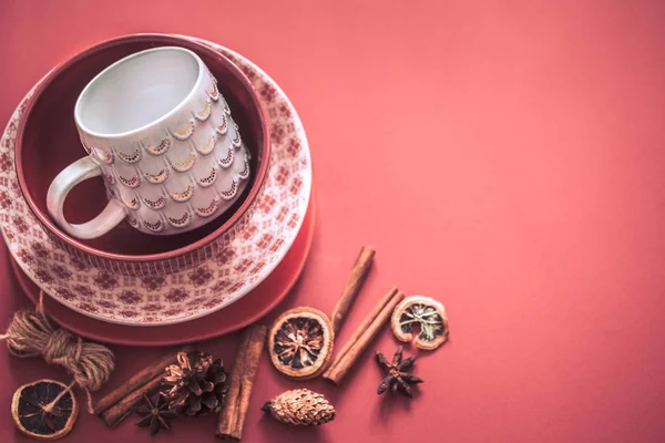 Beautiful dish utensils with a handmade cup on a colored red background