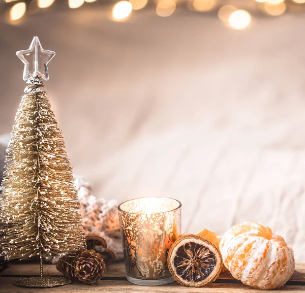 Festive Christmas cozy atmosphere with home decor and tangerines on a wooden background, home comfort concept