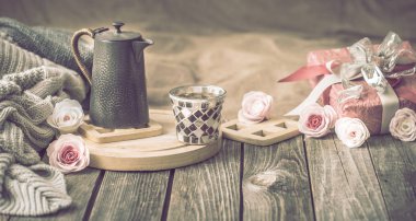 Sevgililer günü ya da anneler günü, çay ile şenlikli bir natürmort ve evde oturma odasında ahşap bir masa üzerinde bir çaydanlık için kavram