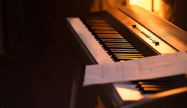 the notes stand on the piano, close-up, beautiful background color, the concept of musical activity