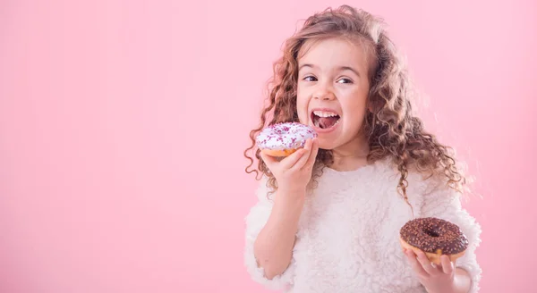 Portrait Little Joyful Cute Curly Girl Who Eats Donuts Pink — Stock Photo, Image