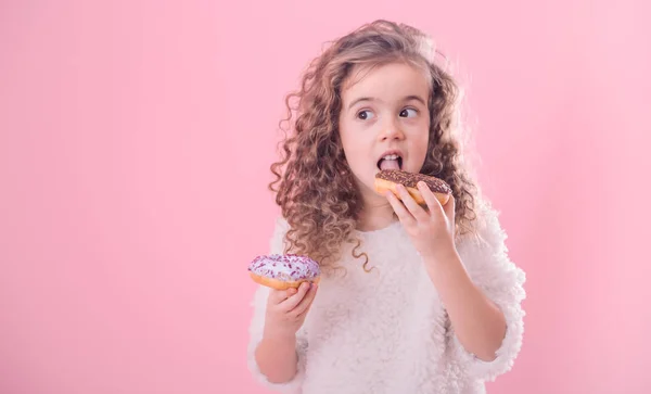 Portrait Little Joyful Cute Curly Girl Who Eats Donuts Pink — Stock Photo, Image