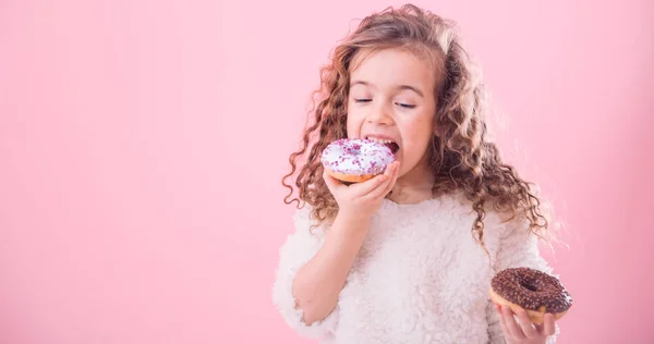 Portrait Little Joyful Cute Curly Girl Who Eats Donuts Pink — Stock Photo, Image