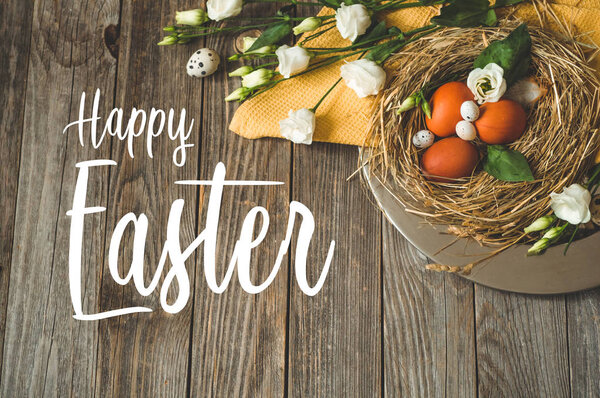 Happy Easter background. Easter eggs in a nest on a metal plate on a wooden background. Quail eggs. Happy Easter concept