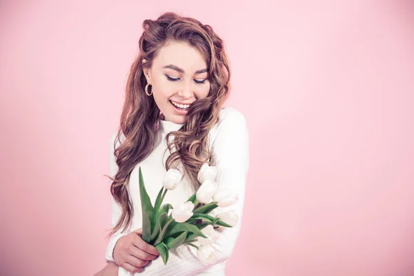 Молода дівчина з тюльпанами на кольоровому фоні — стокове фото