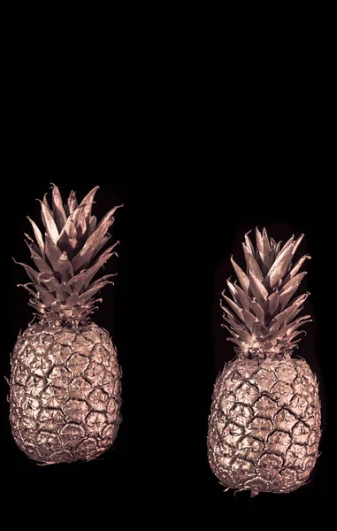 Golden pineapple on black isolated background creative and art