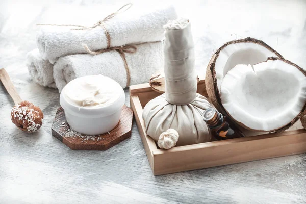 Spa still life with fresh coconut and body care products