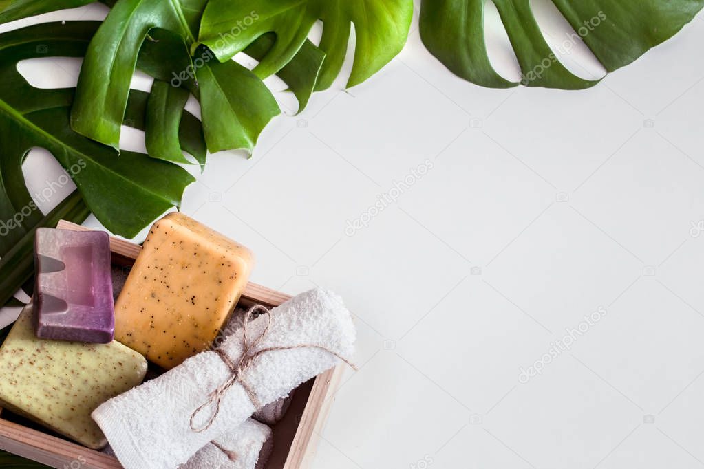 Spa composition with tropical leaves on white background