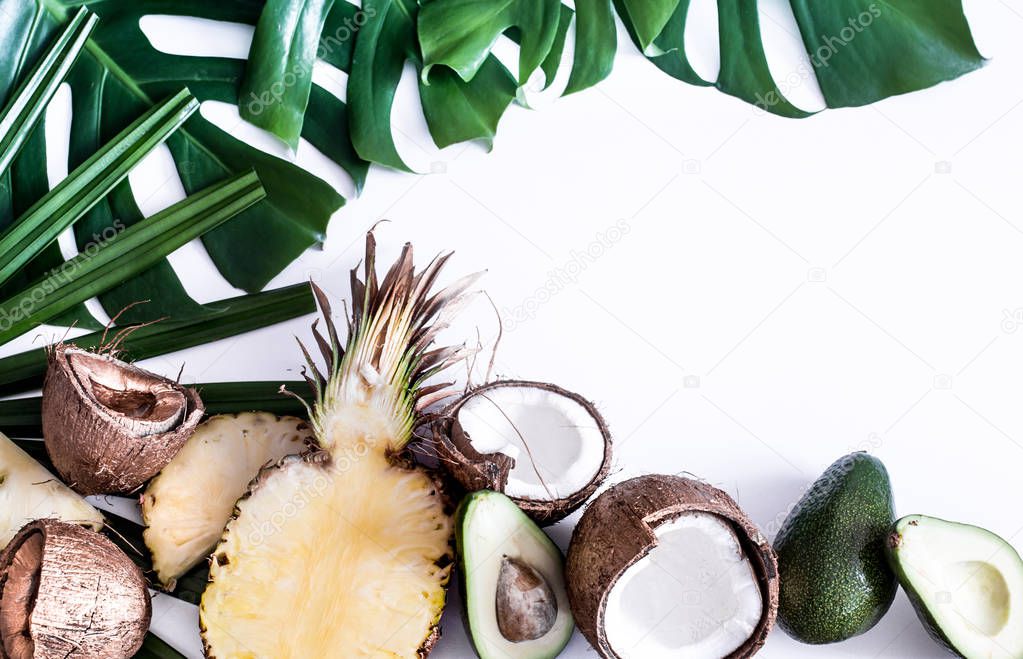 summer composition with tropical leaves and fruits on white background