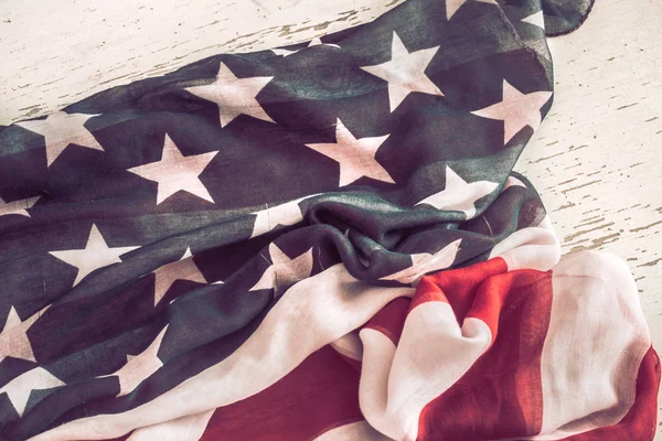 Patriotic symbolism. American flag on wooden background