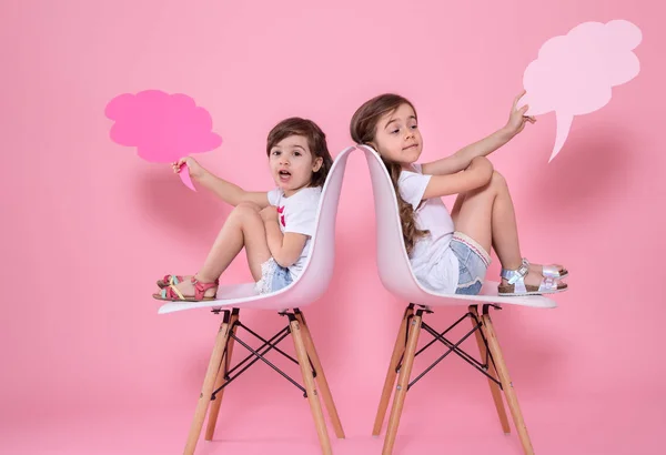 two girls on a colored background with speech icons