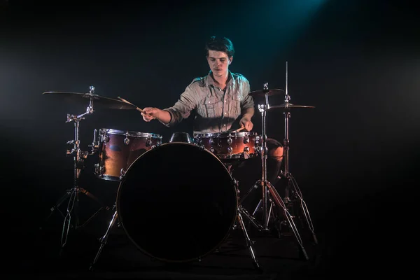 musician playing drums, black background and beautiful soft ligh