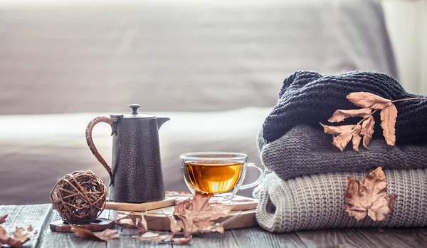 Cozy autumn still life with a cup of tea