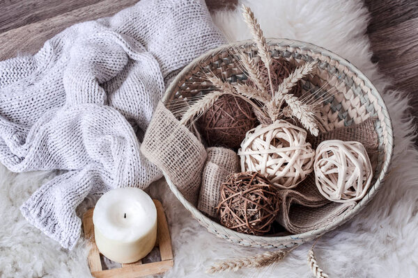 Cozy home still life with wicker basket with decor.