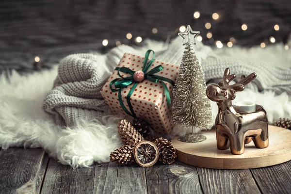 Christmas festive background with toy deer with a gift box and C