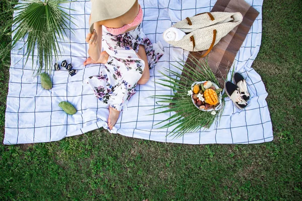 Summer picnic, girl with a plate of fruit