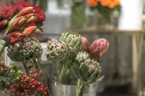 Exotic flowers are the red Amaryllis, artichoke and Protea flowe