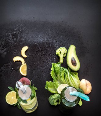 Doğal smoothies siyah bir arka plan üzerinde cam şişelerde içki .