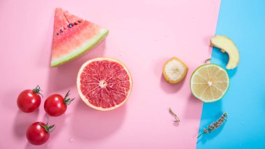 Renkli bir arka plan üzerinde farklı meyve ve sebzeler.