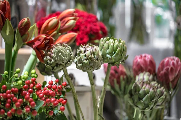 Exotic flowers are the red Amaryllis, artichoke and Protea flowe