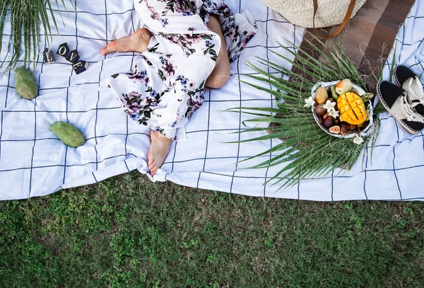 Summer picnic, girl with a plate of fruit