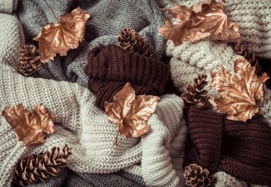 Sonbahar arkaplanı rahat süveterler ve altın yapraklarla .