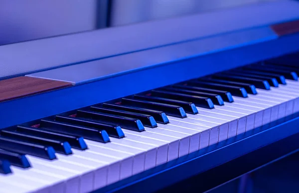 Piano keys on a beautiful colored background. Close up.