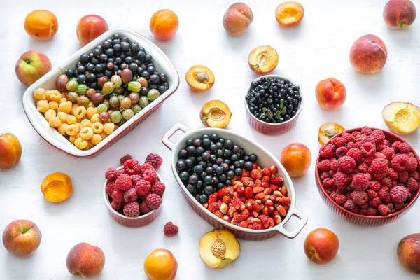 Summer vitamin food concept, various fruit and berries . creative flat lay on light background top view copy space. The concept of healthy eating.