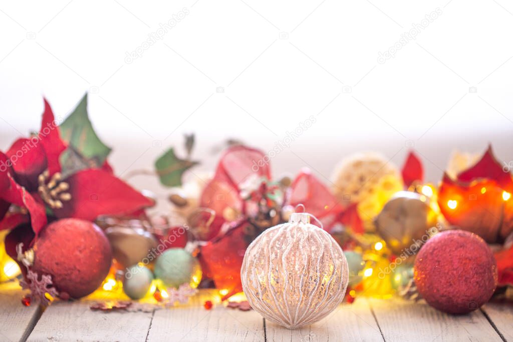 Beautiful Christmas background with Christmas toys and light bulbs in the back . The concept of greeting and celebrating the New year