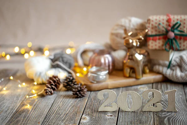 New year\'s holiday composition with wooden numbers 2021 and festive decor . The concept of celebrating the new year.
