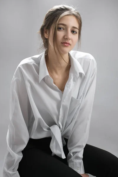 Beautiful Young Woman White Shirt Sitting Looking Camera Isolated Grey — Stock Photo, Image