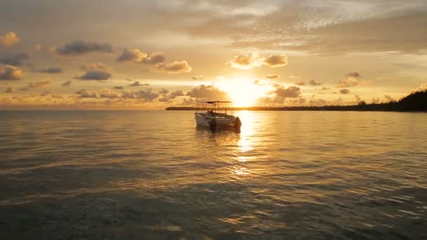 El barco se mece en las olas en los rayos del atardecer — Vídeos de Stock