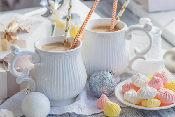 Cup of cacao with marshmallow, meringues and different Christmas decorations, soft focus background