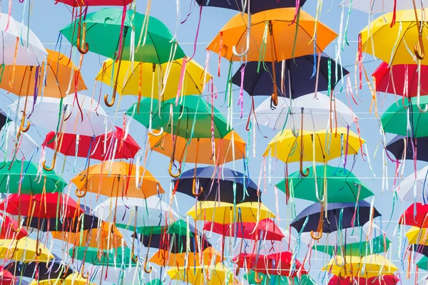 Colored umbrellas hanging above the street, soft focus background