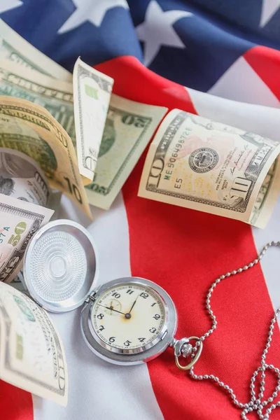 Кишенькові годинники та американських доларів на державному прапорі США, фону — стокове фото