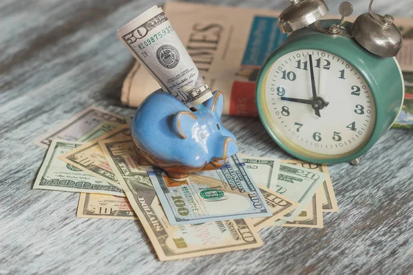 Piggy bank, alarm clock and American dollars — Stock Photo, Image
