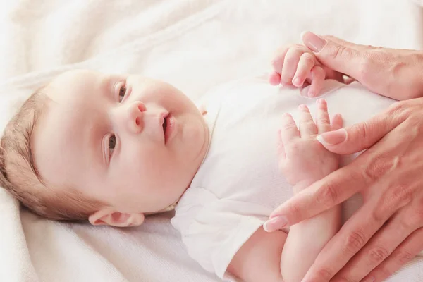 Baby and hands of mother, indoors, blurred background Royalty Free Stock Images