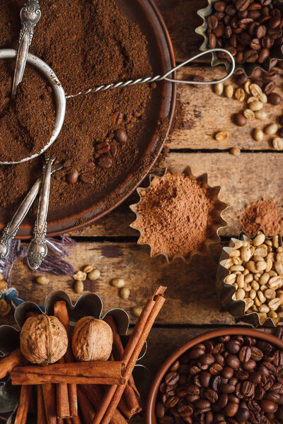 Roasted black and green coffee beans and ground coffee in the plate