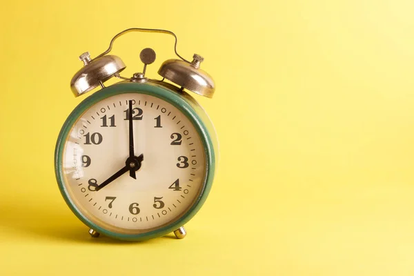 Green Alarm Clock Saturated Yellow Background — Stock Photo, Image