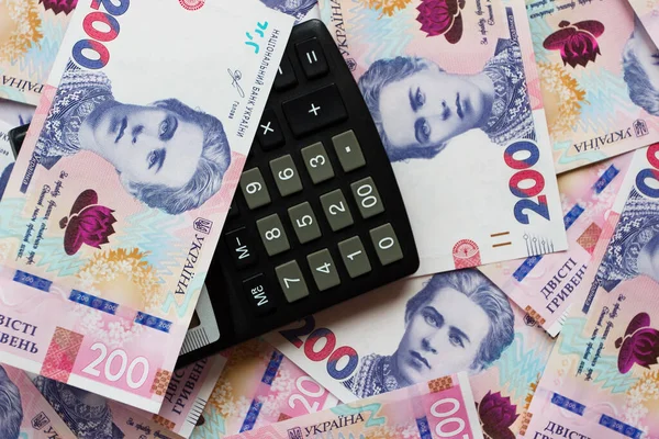 Hesap makinesi ve iş konsepti olan 200 hryvnianın arkaplanı