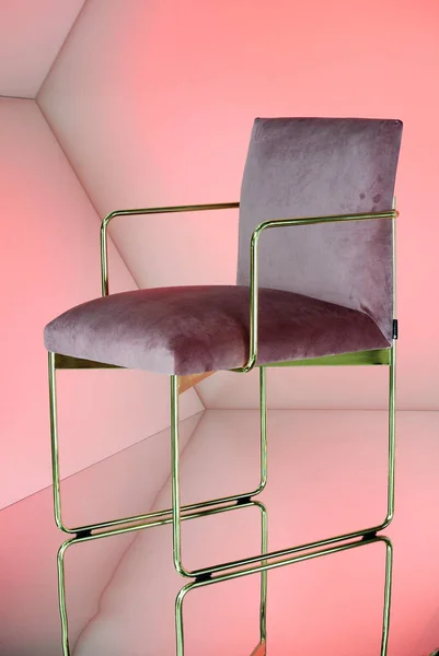 chair in pink fabric and golden metal