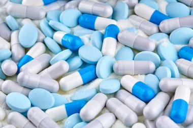 Many blue capsules and tablets.  clipart