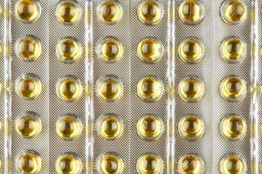 Şeffaf kapsül paketiyle mühürlü. Makro arka plan.