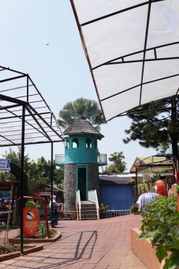 An artificial lighthouse that serves as a boat ride in a theme park
