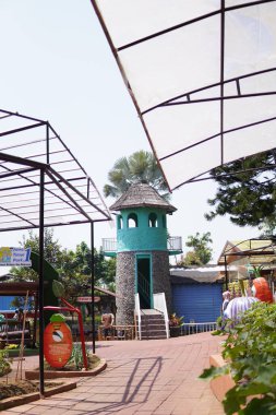 An artificial lighthouse that serves as a boat ride in a theme park