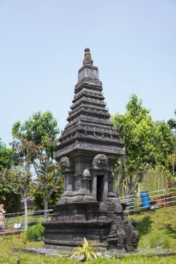 Miniature stone temples displayed outdoors in a theme park for educational purposes.
