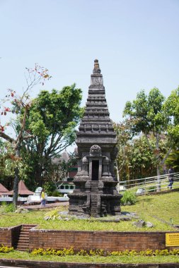 Miniature stone temples displayed outdoors in a theme park for educational purposes.
