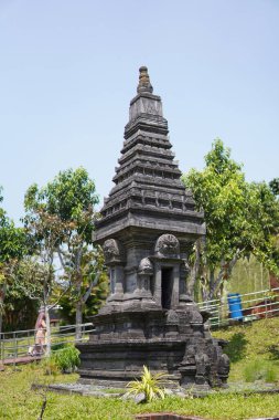 Miniature stone temples displayed outdoors in a theme park for educational purposes.