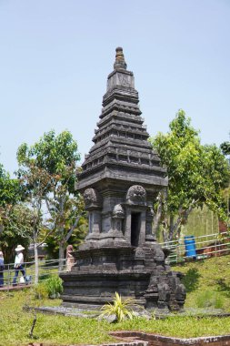 Miniature stone temples displayed outdoors in a theme park for educational purposes.