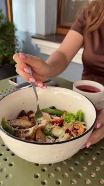 Sezar salatası çatalla karıştırılıp yenir öğle yemeği çayı toplanır. Yüksek kalite 4k görüntü